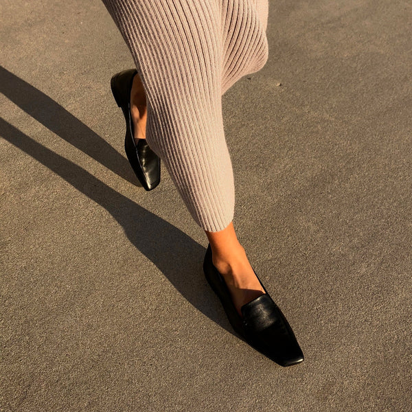 Neil J Rodgers black Liscia loafer with a pointed square toe and minimal stitching in soft Italian nappa leather paired with a blush ribbed sweater dress.