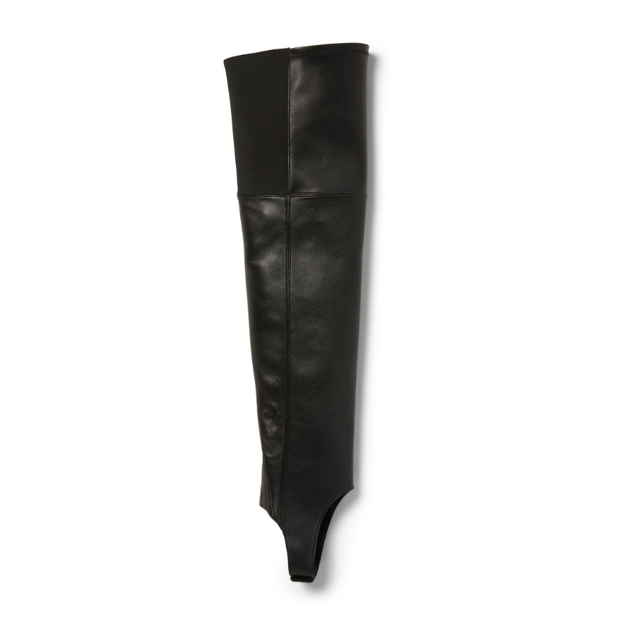 Neil J Rodgers Tik over the knee gaiter designed to be worn with the Tik ankle boot is a stirrup style that attaches over the sole next to the heel. Made of black Italian stretch nappa leather and an elasticized band, the gaiter fits over the knee.