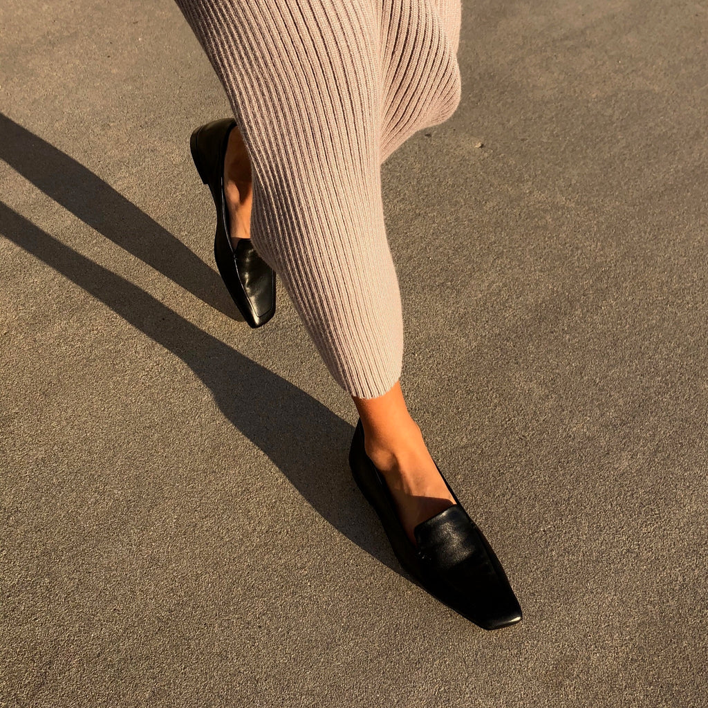 Neil J Rodgers black Liscia loafer with a pointed square toe and minimal stitching in soft Italian nappa leather paired with a blush ribbed sweater dress.