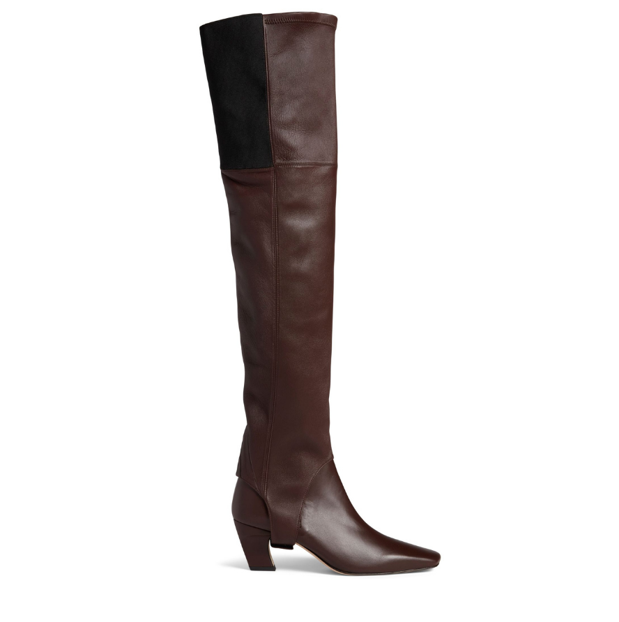 Neil J Rodgers Tik over the knee gaiter designed to be worn with the Tik ankle boot is a stirrup style that attaches over the sole next to the heel. Made of bruciato Italian stretch nappa leather and an elasticized band, the gaiter fits over the knee.