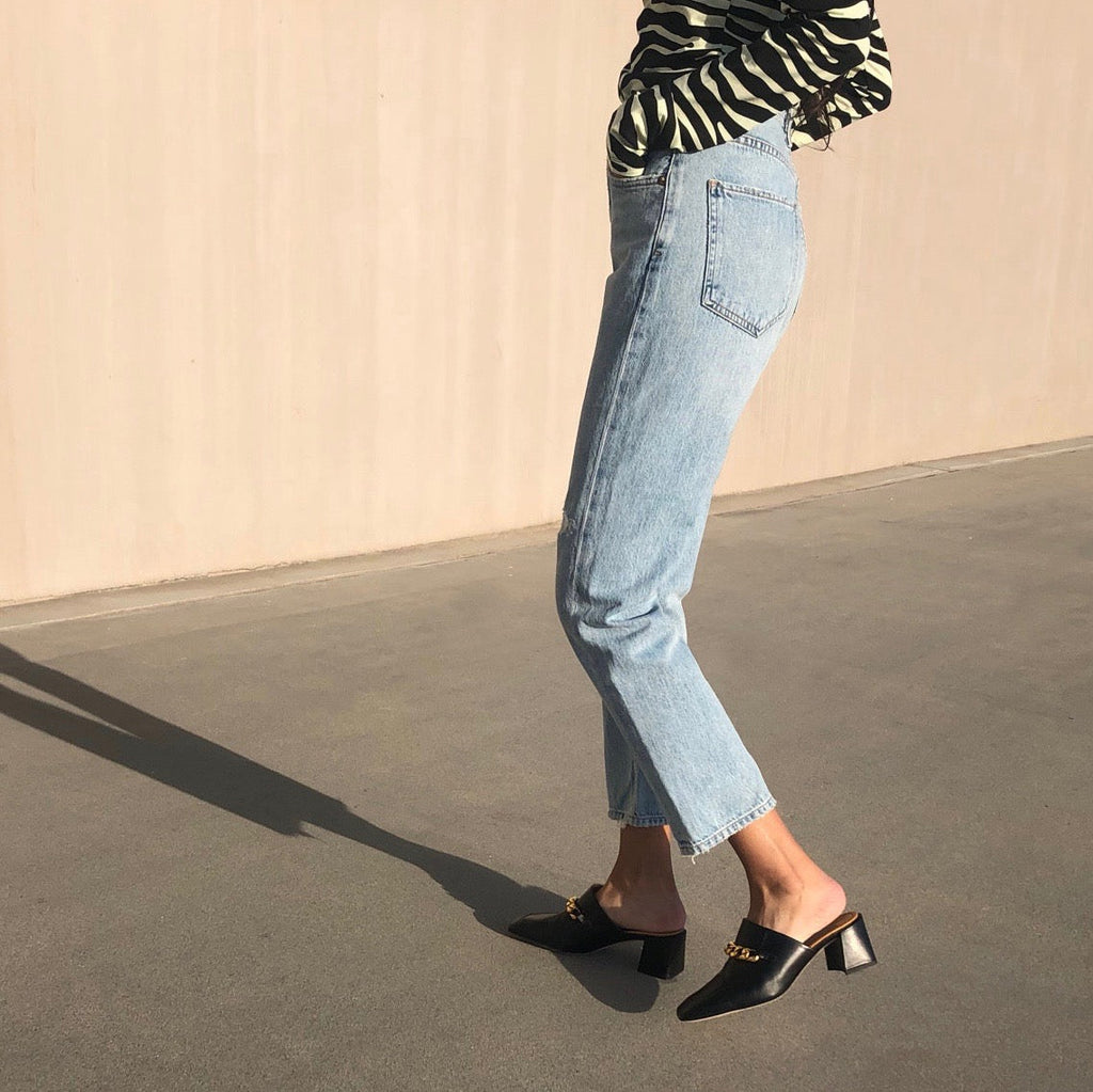 Neil J Rodgers black Laura loafer with chain detail and comfortable block heel paired with straight leg distressed denim and a zebra-print long sleeve top.