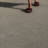 Video of Neil J Rodgers burgundy Obi slide sandal with padded leather straps, comfortable flat footbed and lightweight thick black sole paired with a midi length white dress.